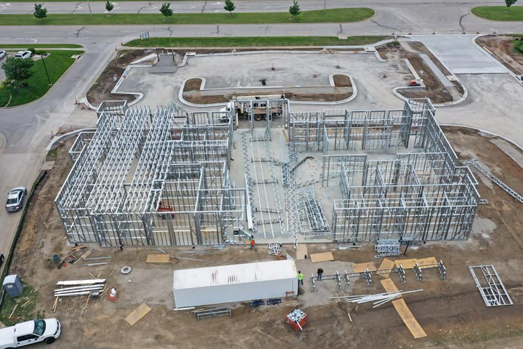 Mobile cold formed steel construction site using onsite steel framing machines for LGSF. Light gauge steel framing built with mobile factory technology.
