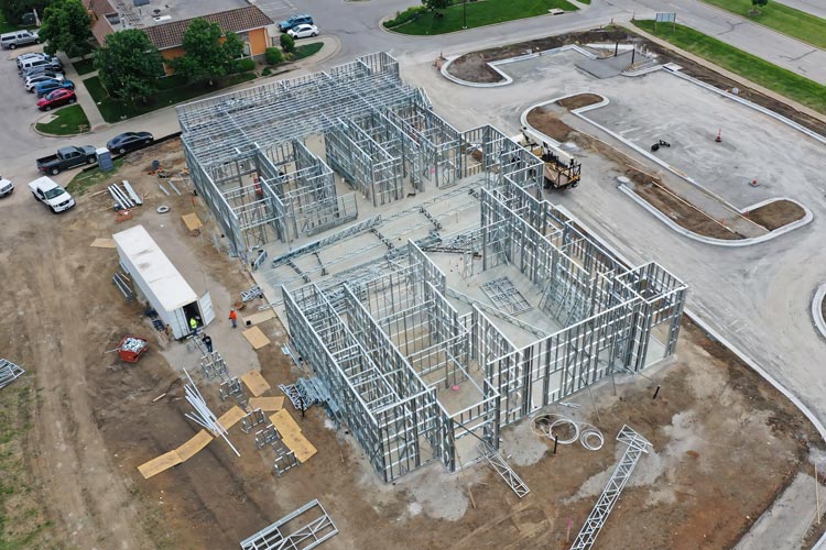 Mobile cold formed steel construction site using onsite steel framing machines for LGSF. Light gauge steel framing built with mobile factory technology.
